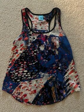 happening in the present Multicolor Abstract Racerback Tank - Blue/Black/Red